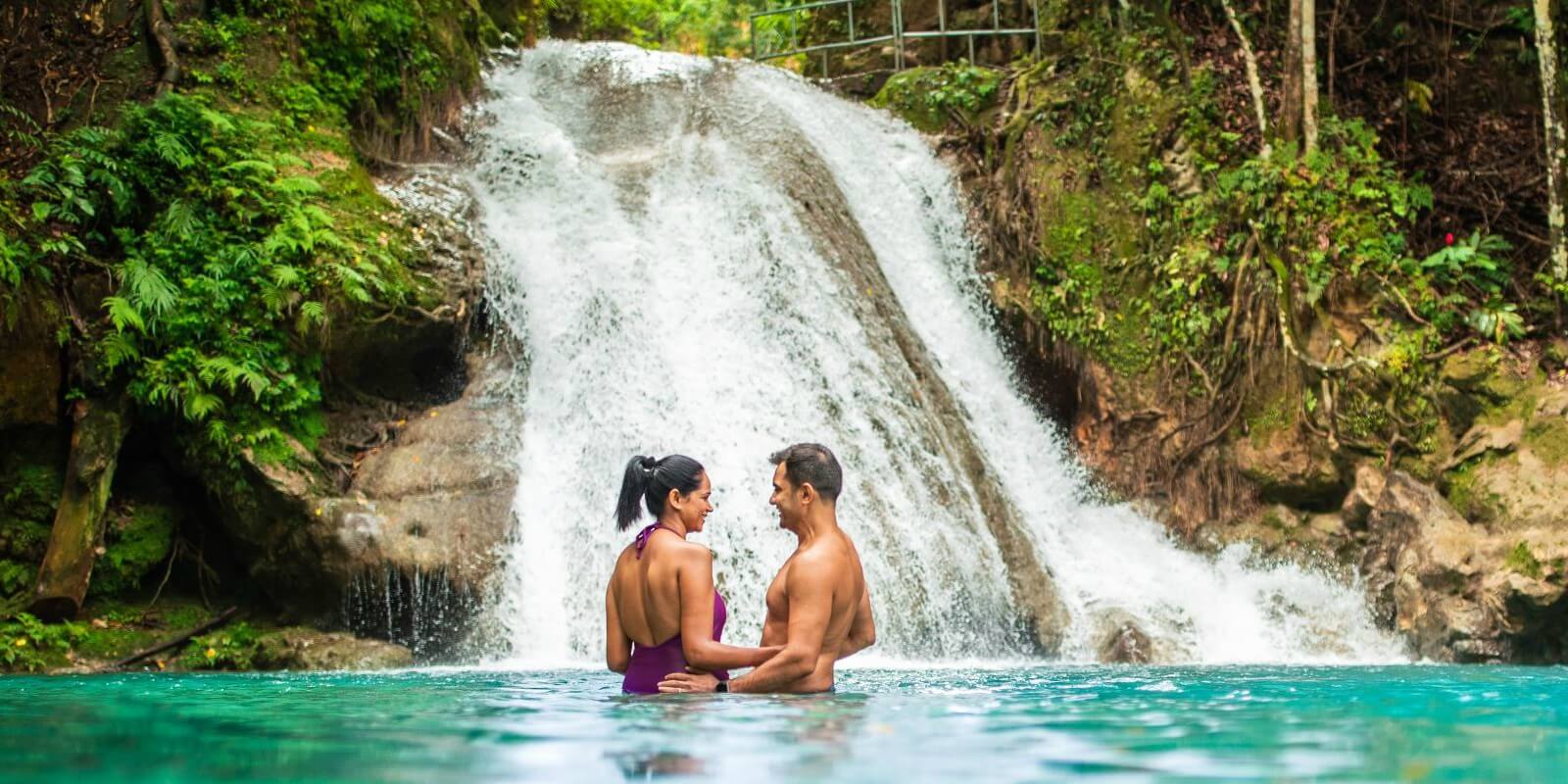 Couple enjoying a secluded Jamaican waterfall