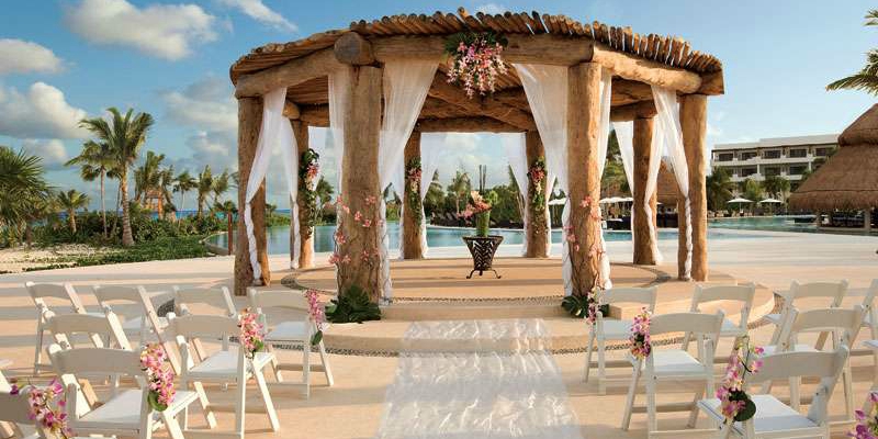 A wooden gazebo decorated for a wedding ceremony