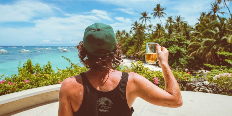 Man drinking a beer in a pool