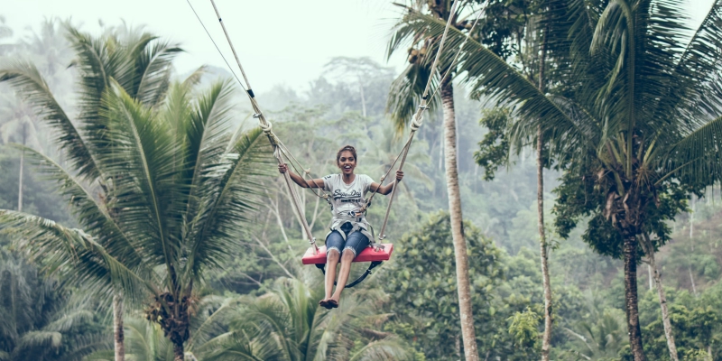 Woman a swing in the jungle