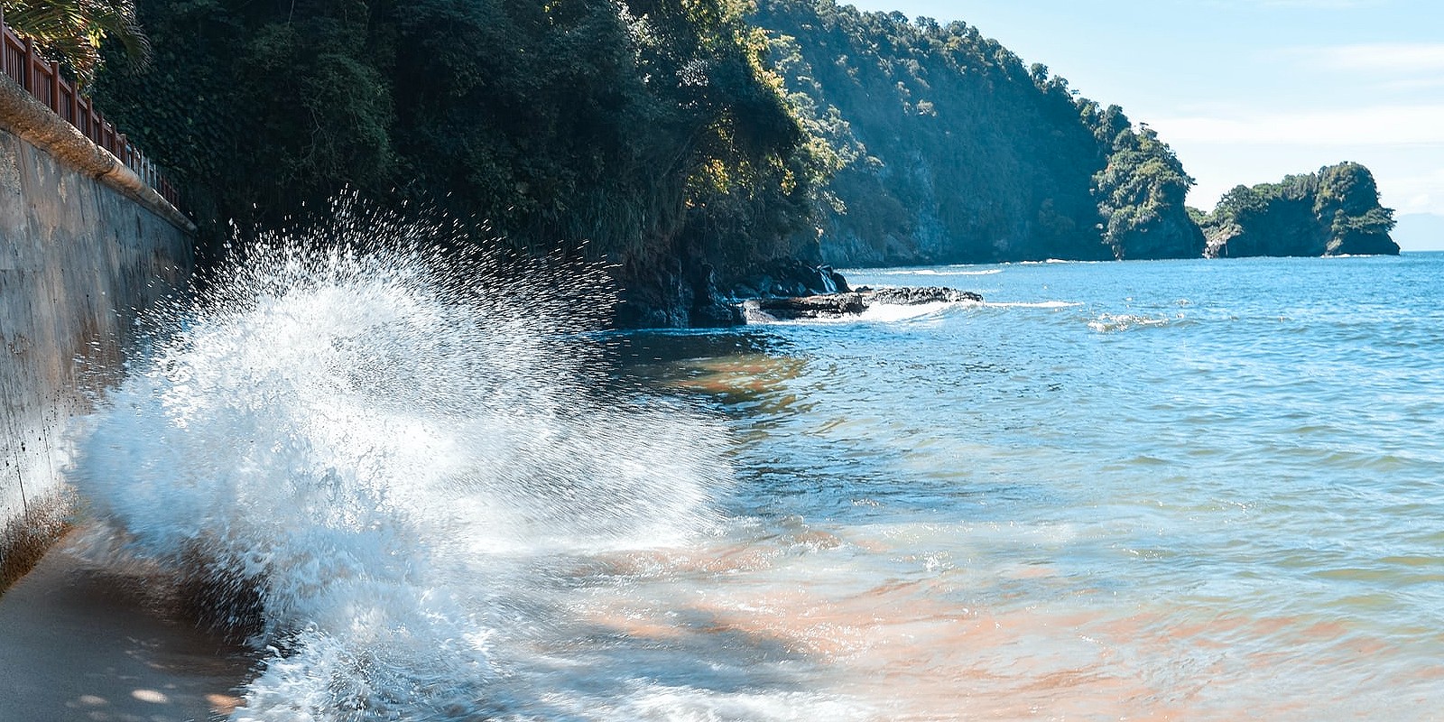 The waves crash against a wall on the coast of Trinidad