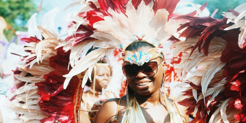 A woman dressed in colourful feathers and swimming costume for Carnival in the Caribbean