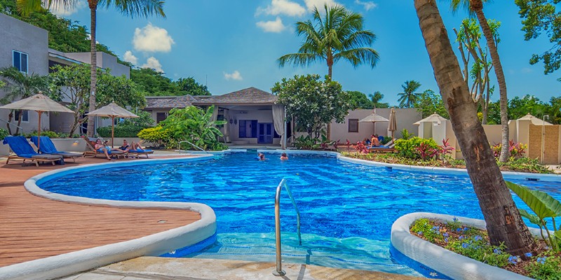 Poolside shot of people lounging at Waves Hotel and Spa, Barbados