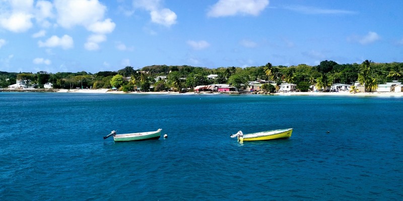 Two boats float of the shore of Barbados