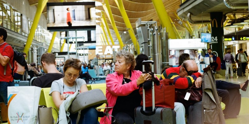 People waiting to travel in an airport