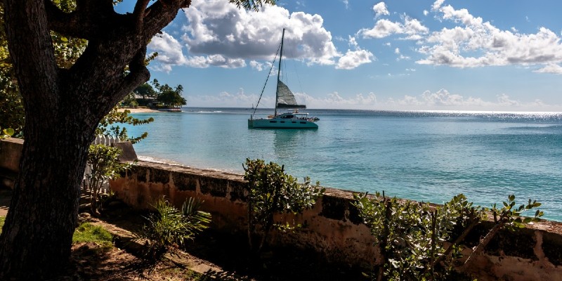 View of the Caribbean Sea from Barbados coast with a boat sailing