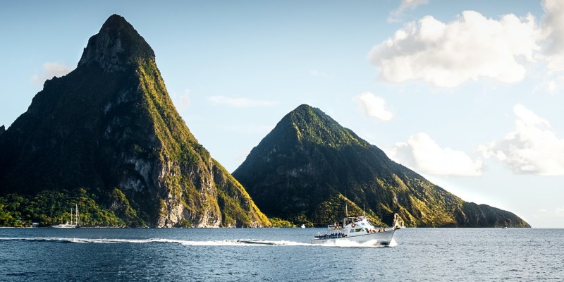 Boat sailing passed the Pitons in St Lucia
