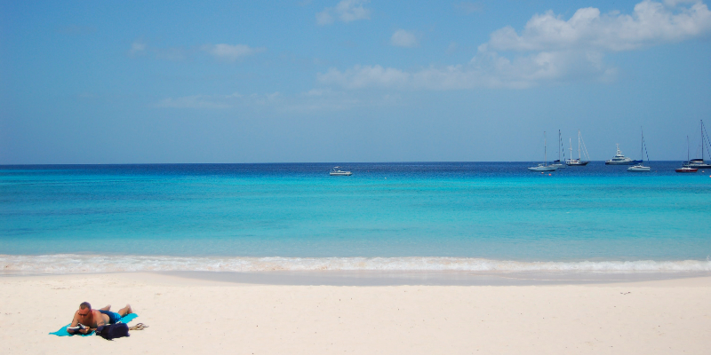 A man sunbathing on a Barbados beach