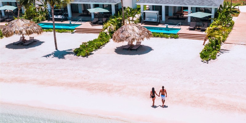 Couple walking on the beach at Excellence Oyster Bay