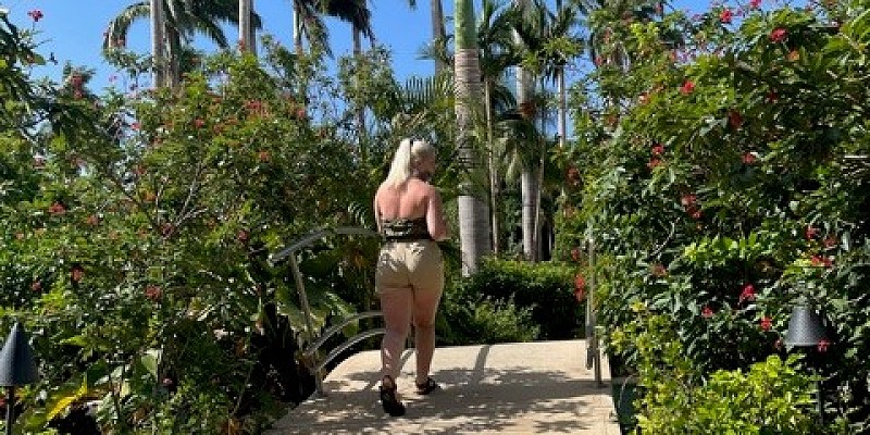 Woman walking through Sandals Barbados resorts gardens