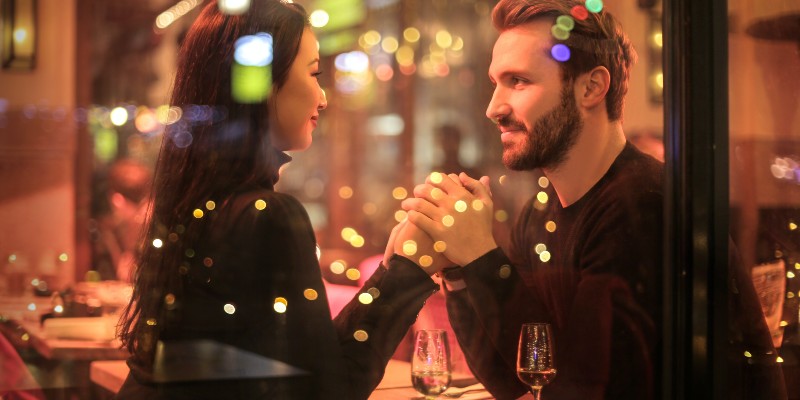 A couple holding hands in a restaurant
