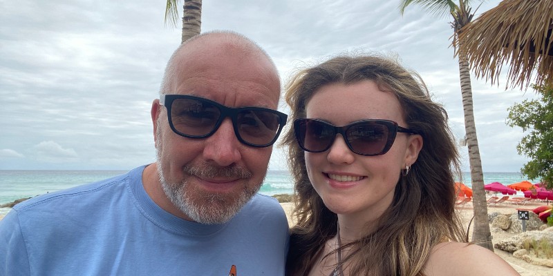 Man and daughter take a selfie on the beach