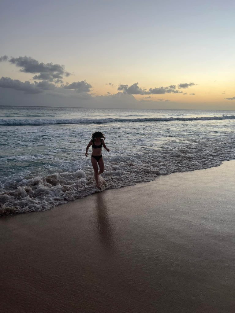 Woman running in the sea in Barbados