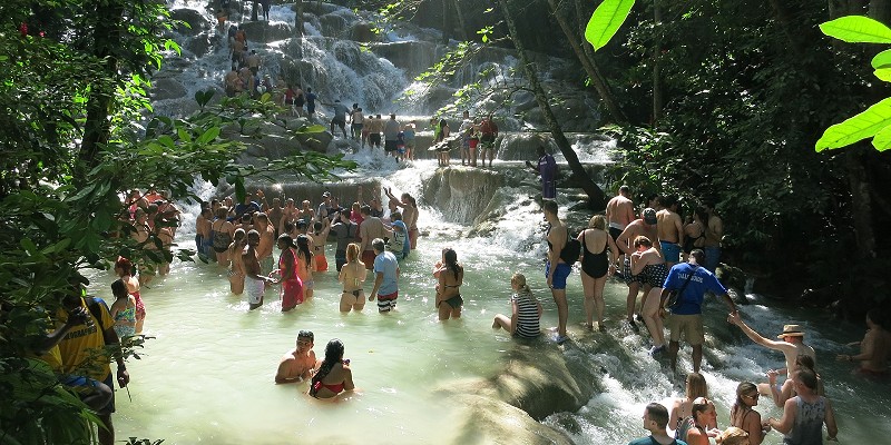 People enjoying a day at the waterfalls in Jamaica