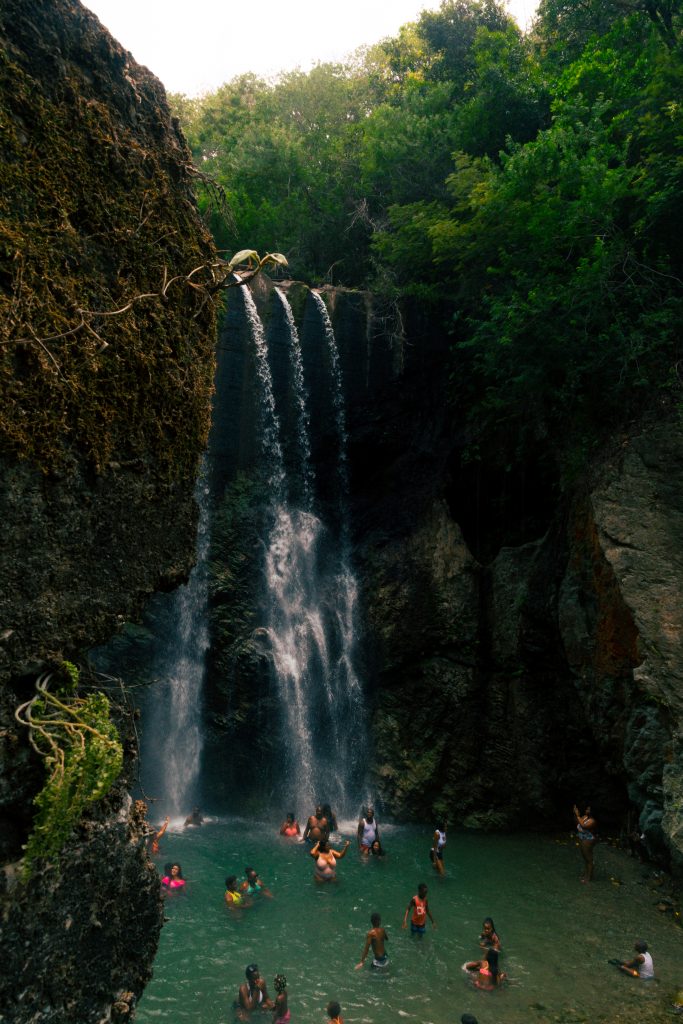 People relaxing in a waterfall