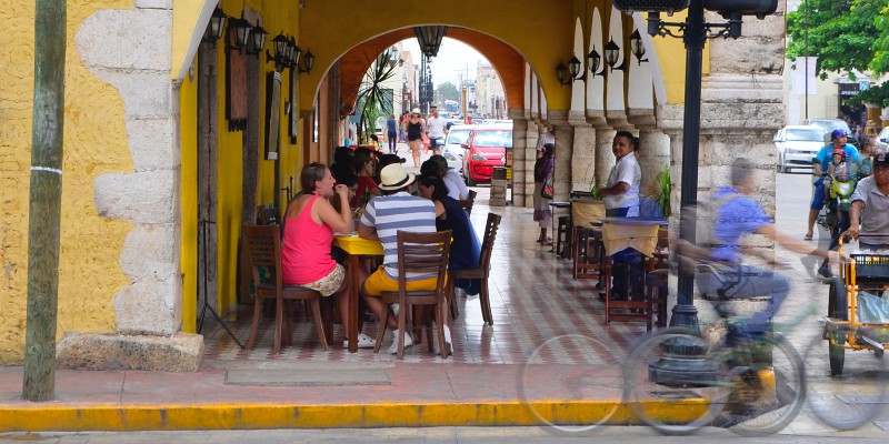 People eating and drinking outside a cantina in Mexico