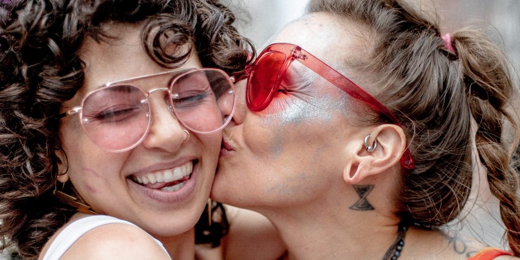 Two women kissing at a Pride Parade