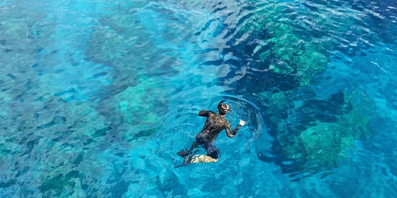 Man snorkelling in clear Caribbean water